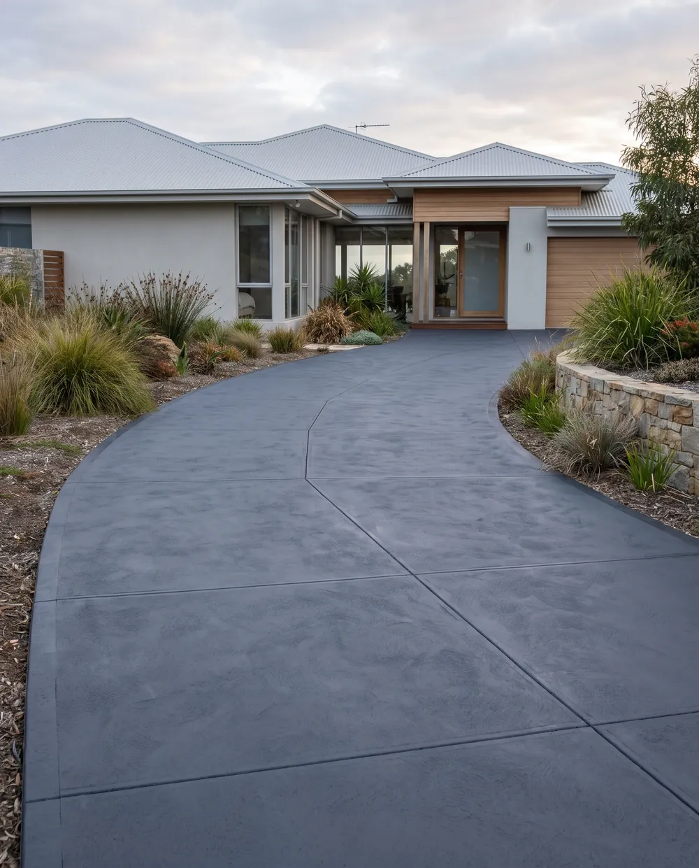 New charcoal coloured concrete driveway after